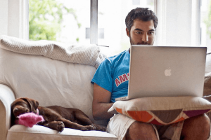 A freelancer sitting with his dog